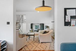 a living room with white chairs and a table at Modern House, Pool, Garden in Burgdorf