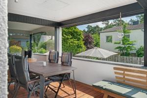 a patio with a table and chairs and a large window at Modern House, Pool, Garden in Burgdorf
