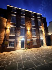 a brick building with lights on the side of it at Fishergate Residences in Preston +23 photos