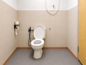 a bathroom with a white toilet in a room at Redang Divers Resort in Redang Island