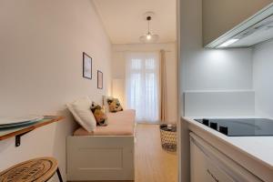 a living room with a couch and a kitchen at Viktor 1 - Studio Hyper Centre - Place Jean Jaurès in Tours