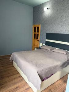 a bedroom with a large bed in a room at ElMar Guesthouse in Sevan
