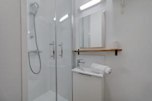 a white bathroom with a shower and a sink at Viktor 1 - Studio Hyper Centre - Place Jean Jaurès in Tours