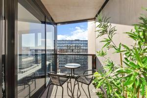 a balcony with a table and chairs on a building at 1BR-1BR-1Car-Sleeps 4-Pool-CBD in Canberra
