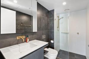 a bathroom with a sink and a toilet and a shower at 1BR-1BR-1Car-Sleeps 4-Pool-CBD in Canberra
