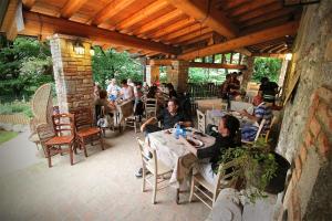 a group of people sitting at tables on a patio at Agriturismo BioBiò in Vobarno