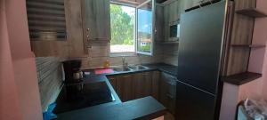 a small kitchen with a sink and a refrigerator at Georgia's house in Maronia