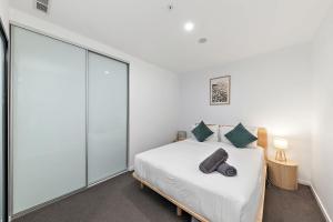 a bedroom with a bed and a glass wall at 2B-1BR-1Car-Courtyard-CBD-Shops in Canberra