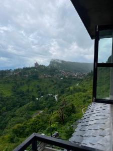 a view of a green valley from a house at Hilltop Horizon Hotel in Bandipur +5 photos