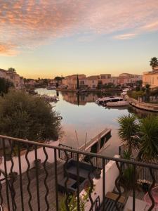 a view of a river from a balcony at Marina with pool in Aigues-Mortes