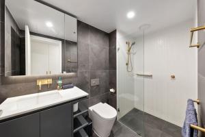 a bathroom with a toilet and a sink and a shower at Central CBD - parking - sleeps 4 in Canberra