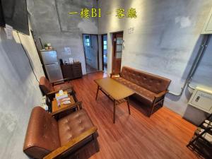 a living room with a couch and a table at 未半文旅 in Yilan City