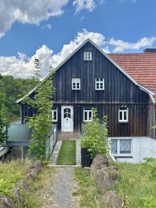 a large wooden barn with a white door at Weiherhof in Ehrenberg