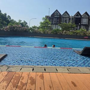 two people are swimming in a swimming pool at OSAKA RIVERVIEW in Tangerang