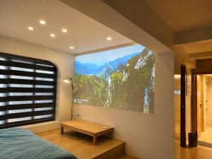 a bedroom with a large window with a mountain view at Yuzu Home Hang Voi in Hanoi