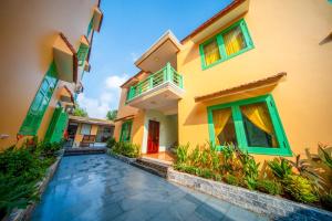 a house with a walkway in front of it at Tam Coc Cosiana Hotel in Ninh Binh