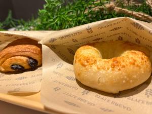 two donuts in a box on a plate at plat hostel keikyu minowa forest in Tokyo