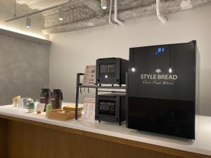 a coffee shop counter with a sign that says style bread at plat hostel keikyu minowa forest in Tokyo