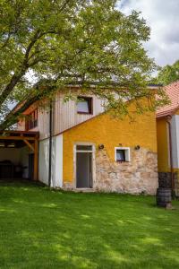 a stone building with a tree in front of it at statek P22 in Semněvice