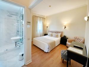 a bedroom with a bed and a bathroom with a shower at Hotel Joao Padeiro in Aveiro +79 photos