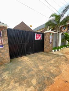 a black fence with a new deal sign on it at St Kora Apartment and Shortlets in Asaba