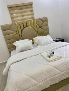 a bedroom with two beds with white sheets at St Kora Apartment and Shortlets in Asaba