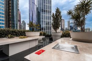 a view of a city from a building with potted plants at Zen Sky Home - Super Centre with Free Car park & Pool in Melbourne