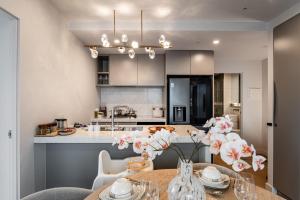 a kitchen with a table and a dining room at Zen Sky Home - Super Centre with Free Car park & Pool in Melbourne