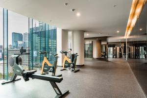 a gym with treadmills and cardio equipment in a building at Zen Sky Home - Super Centre with Free Car park & Pool in Melbourne