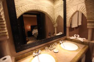 a bathroom with two sinks and a large mirror at Riad Dar Haven in Tamraght Ou Fella