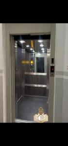 an elevator with a sign on the door of it at Winner house in Oran