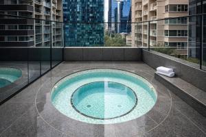 a swimming pool on the roof of a building at Zen Sky Home - Super Centre with Free Car park & Pool in Melbourne