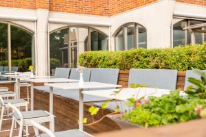 a row of tables and chairs on a patio at Radisson Blu Arlandia Hotel, Stockholm-Arlanda in Arlanda