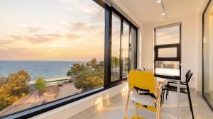 an office with a desk and a window overlooking the ocean at Goseong Belossi Ayajin Kids Poolvilla in Goseong