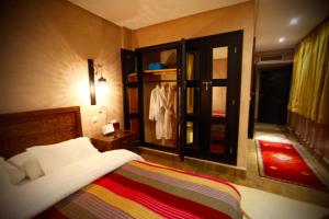 a bedroom with a bed and an open window at Riad Dar Haven in Tamraght Ou Fella