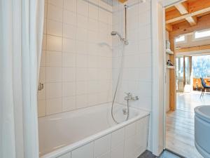 a bathroom with a bath tub and a toilet at Luxury Alpine Chalet with incredible Views in Lenk