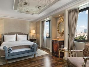 a bedroom with a bed and a chair and a window at Rixos Pera Istanbul - Nickelodeon Play Access in Istanbul +123 photos