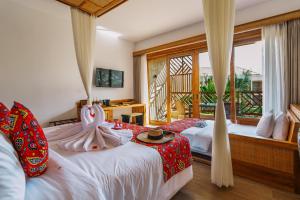 a bedroom with two beds and a window at Anaya Hotel Zanzibar in Pwani Mchangani +84 photos