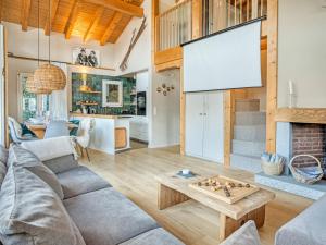 a living room with a couch and a table at Luxury Alpine Chalet with incredible Views in Lenk