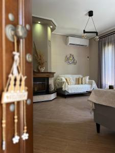 a living room with a bed and a couch at Villa iliotropio in Lefokastro
