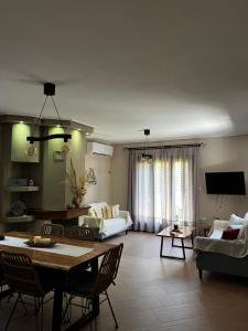a living room with a couch and a table at Villa iliotropio in Lefokastro