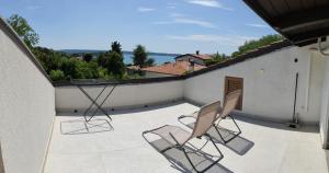two chairs sitting on a balcony with a view at Rose in Portorož