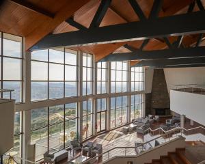 a large room with large windows and chairs at Alfândega da Fé Hotel & SPA in Sambade