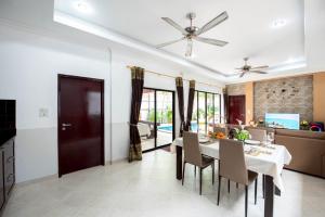 a dining room with a table and chairs at MM Pool Villa in Pattaya South