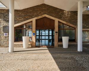 an entrance to a building with glass doors at Alfândega da Fé Hotel & SPA in Sambade
