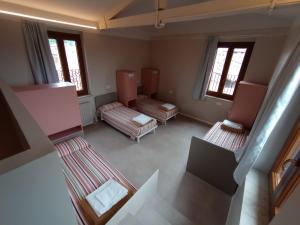 an overhead view of a room with two beds and windows at Protezione della Giovane - female hostel in Verona