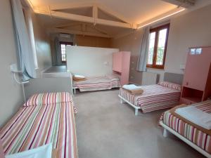 a room with three beds in a room at Protezione della Giovane - female hostel in Verona