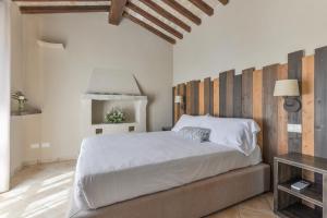 a bedroom with a large bed with a wooden headboard at Agriturismo Galenzana in Marina di Campo