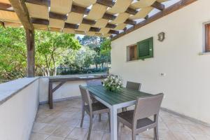 a patio with a table and chairs on a patio at Agriturismo Galenzana in Marina di Campo