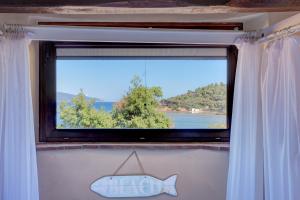 a window with a fish sign in front of it at Agriturismo Galenzana in Marina di Campo
